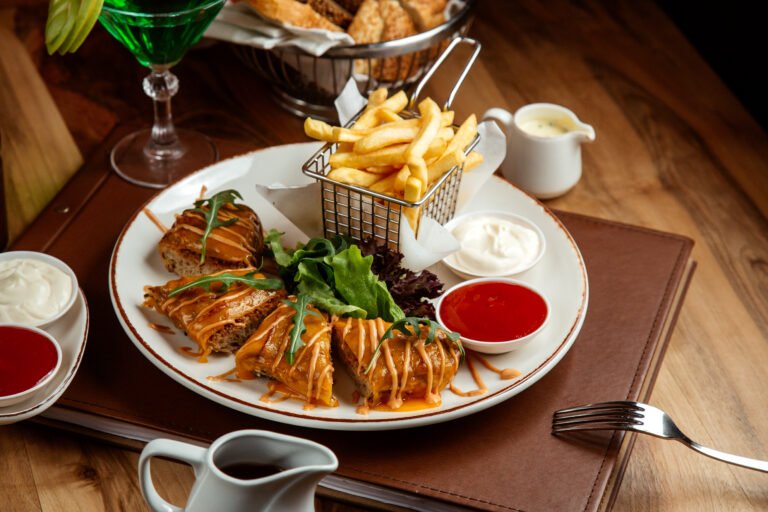 side view meat cutlet with french fries ketchup mayo tarhun lemonade and bread on the table